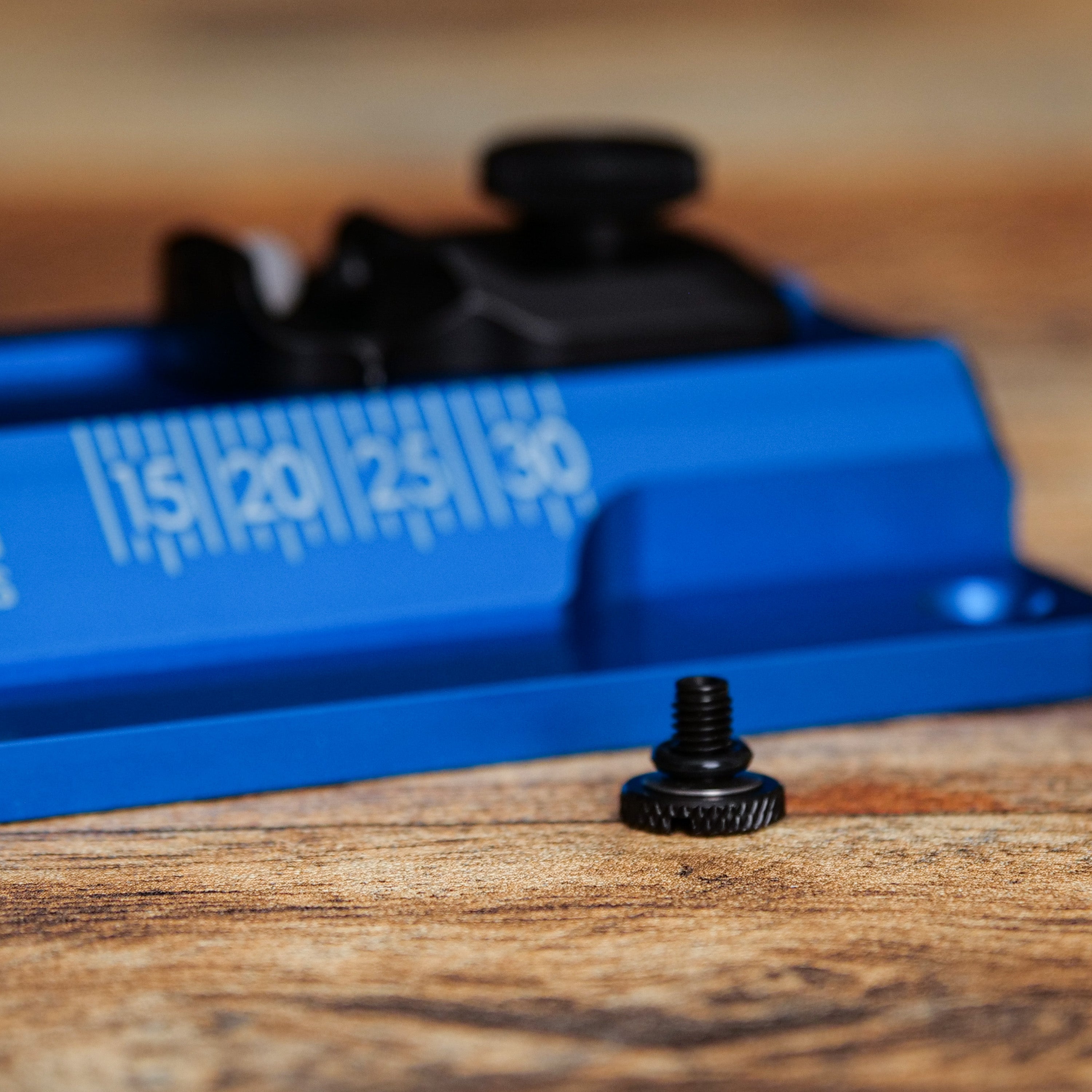 60 Series Pivot Screw Parts Pack in close-up on wooden surface with blue ruler from front angle.