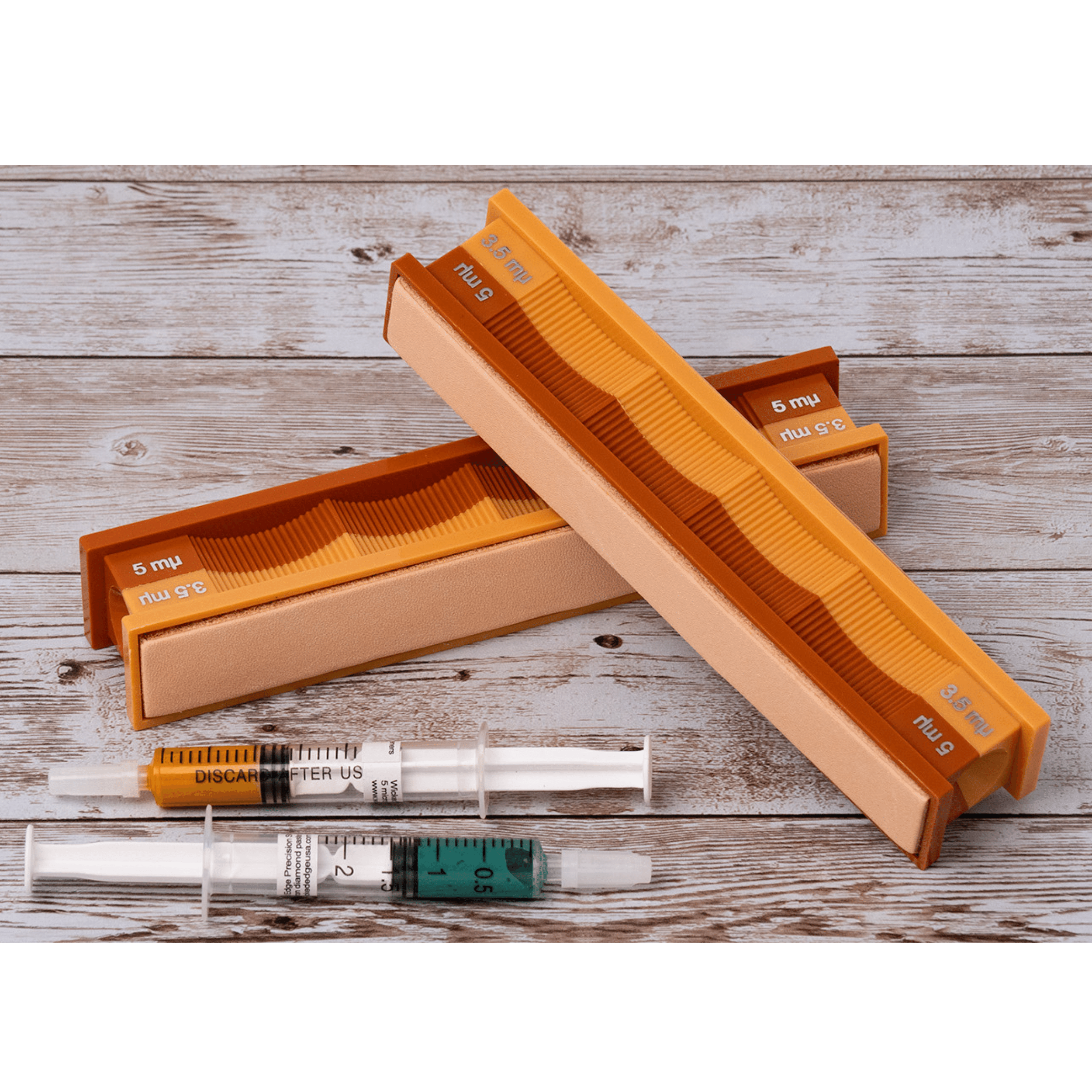 5/3.5 micron diamond and leather strops pack in open box on weathered wood surface, close-up front view.