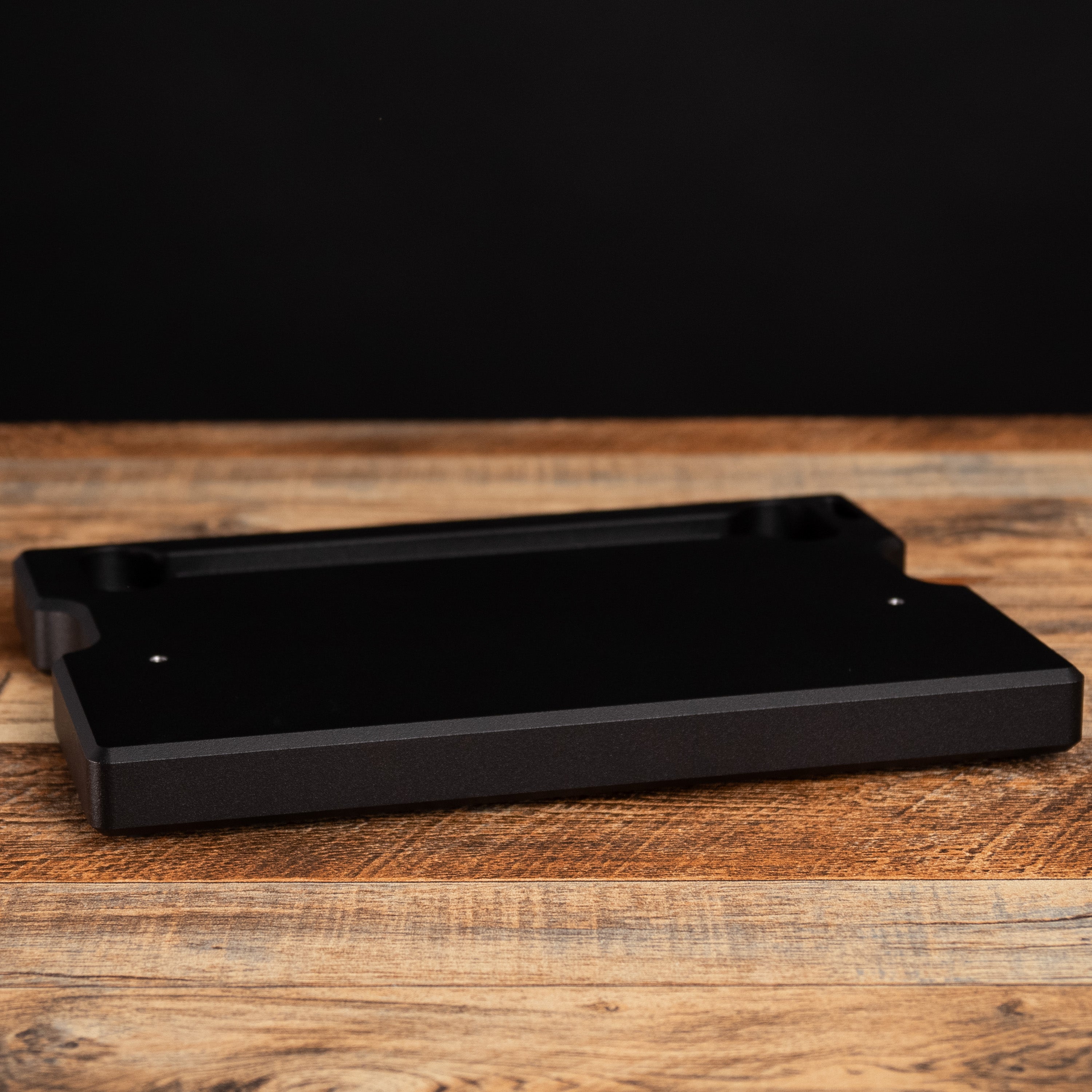 Wicked Edge Aluminum Base in studio on wooden surface at close-up from front angle.