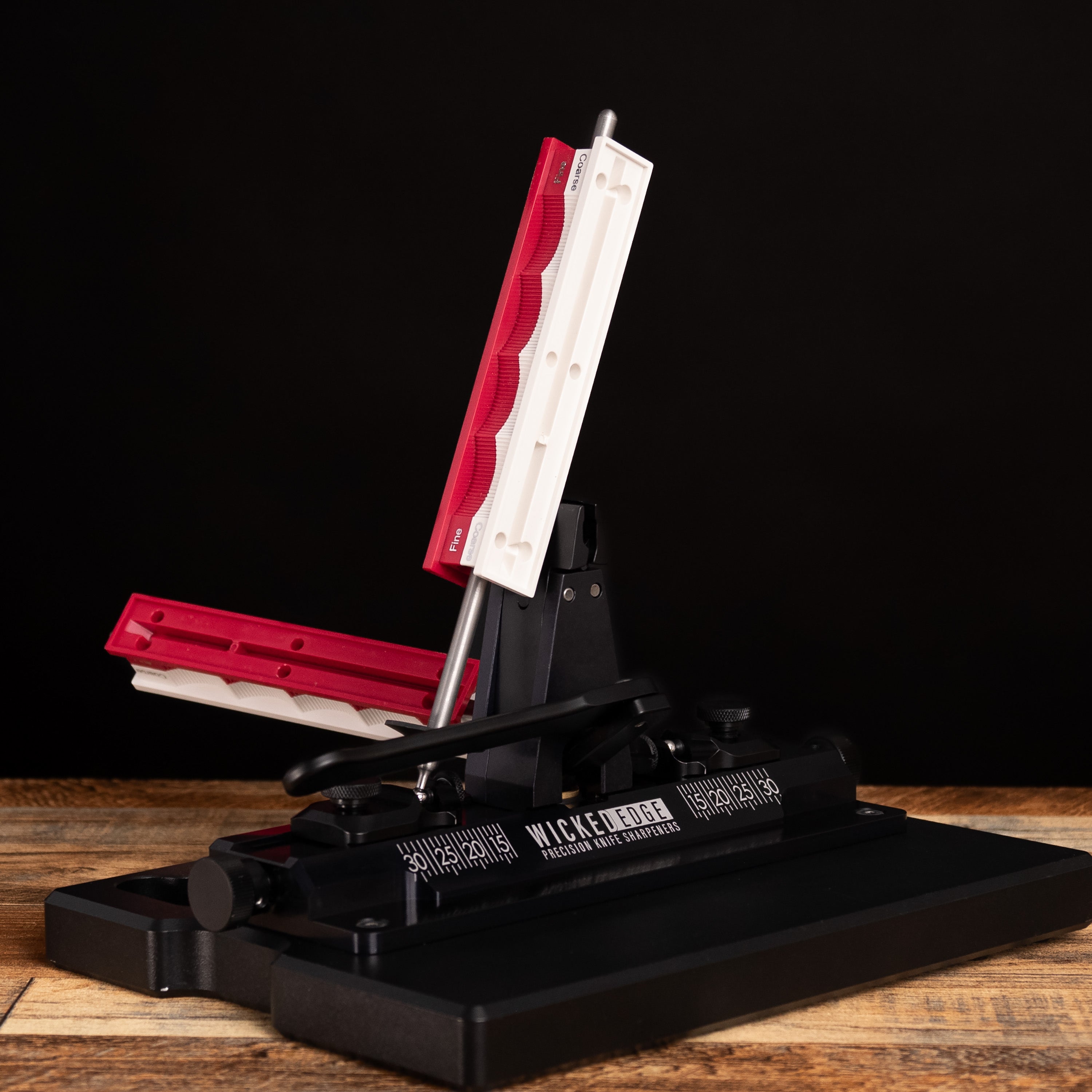 Blank Handles Pack mounted in Wicked Edge precision knife sharpener at close-up from side angle.