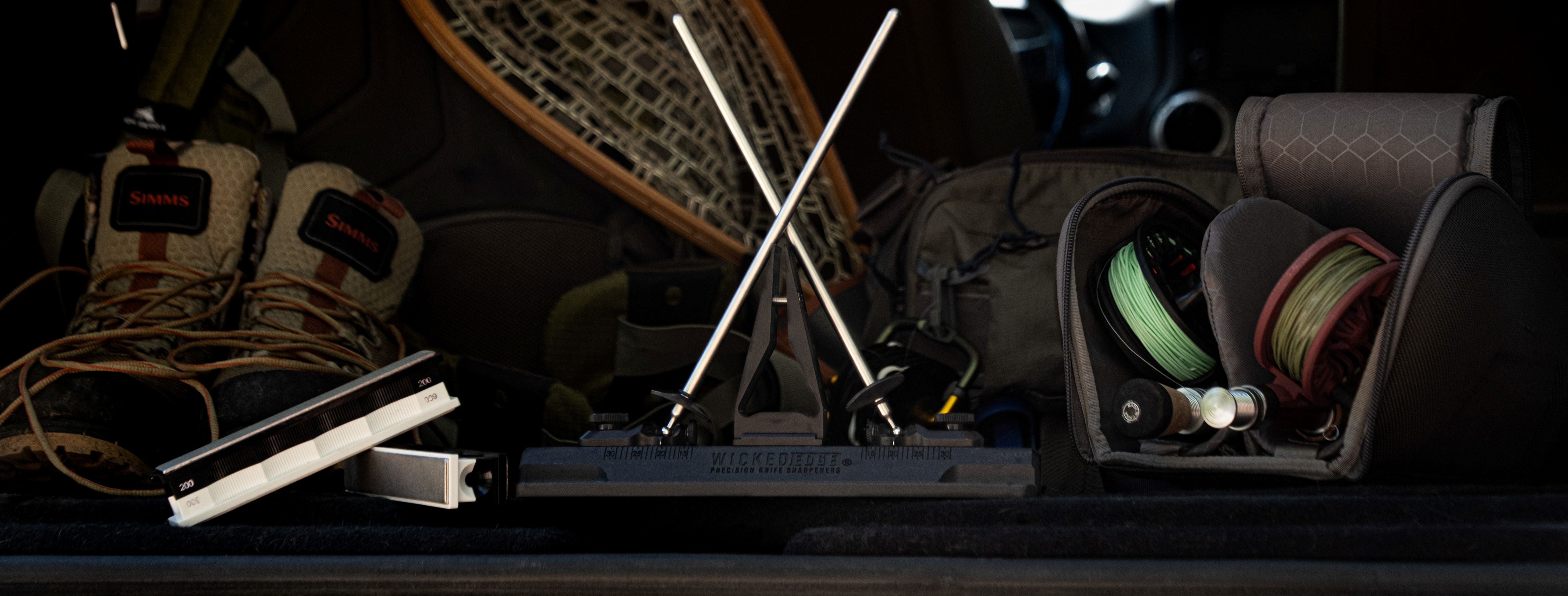 Backpack and outdoor gear inside a vehicle with a focus on crossbows and equipment.