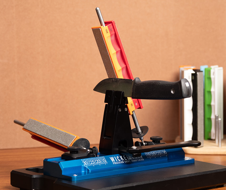 Premium 100/200 grit diamond sharpening stones pack mounted in Wicked Edge precision sharpener at close-up view from front angle.