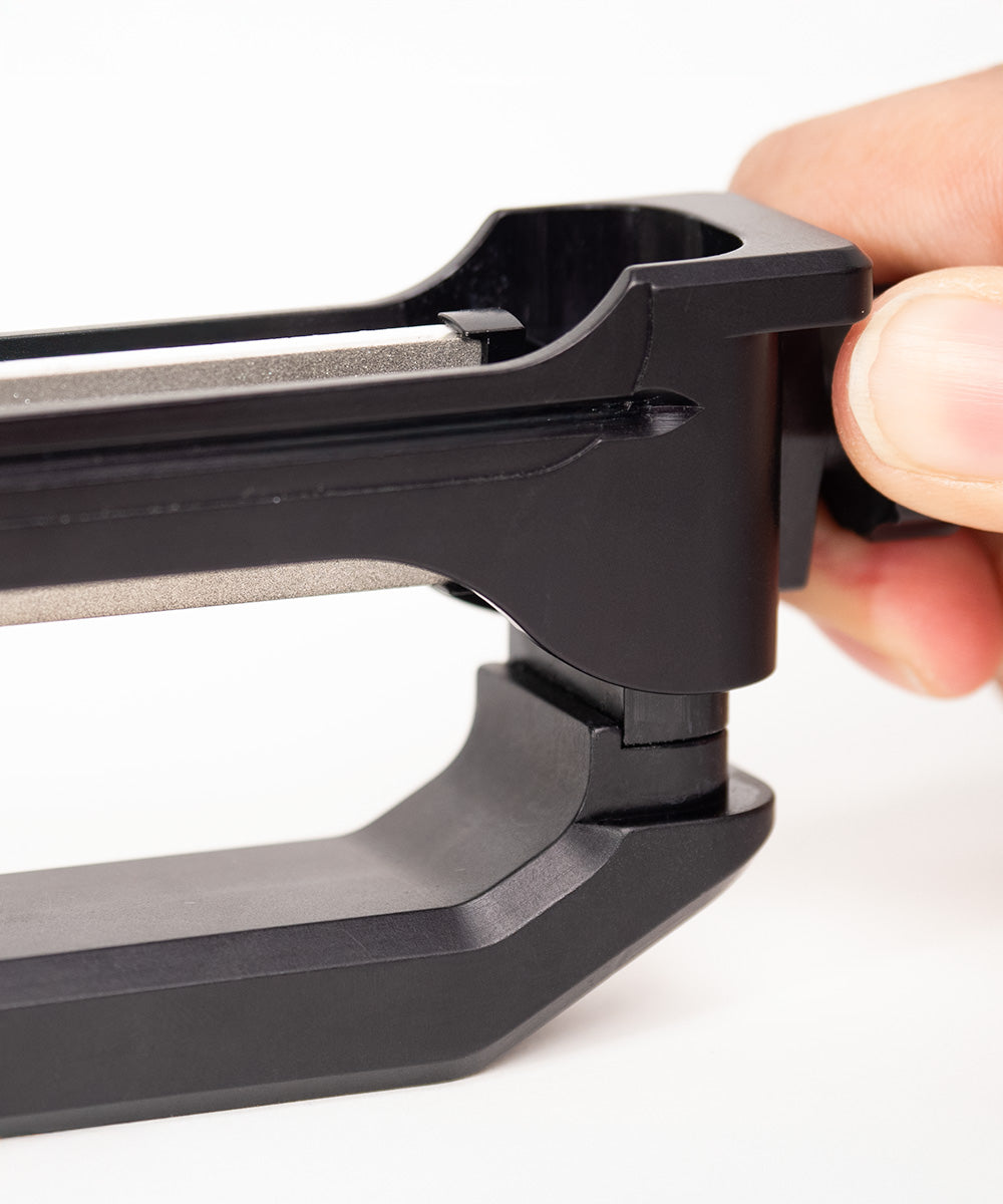 WE26 Venture Pro portable precision knife sharpener stone change mechanism in use. Close up view.