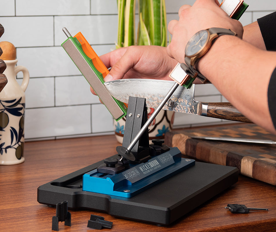 Wicked Edge GO dual-sided precision knife sharpener in kitchen setting at close-up from front angle.
