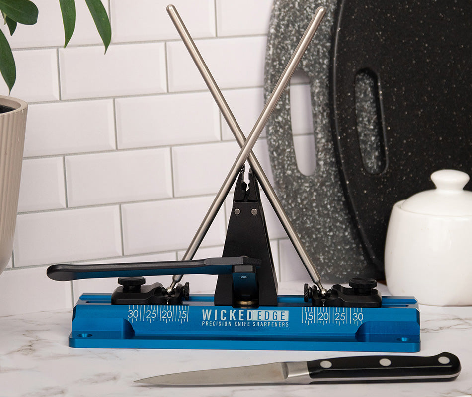 Wicked Edge Cobalt WE64 dual-sided precision knife sharpener in kitchen setting at close-up from front angle.