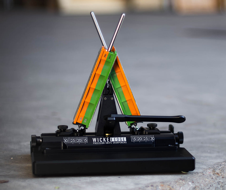 Wicked Edge Obsidian WE66 dual-sided knife sharpener in studio setting at close-up zoom from front angle.