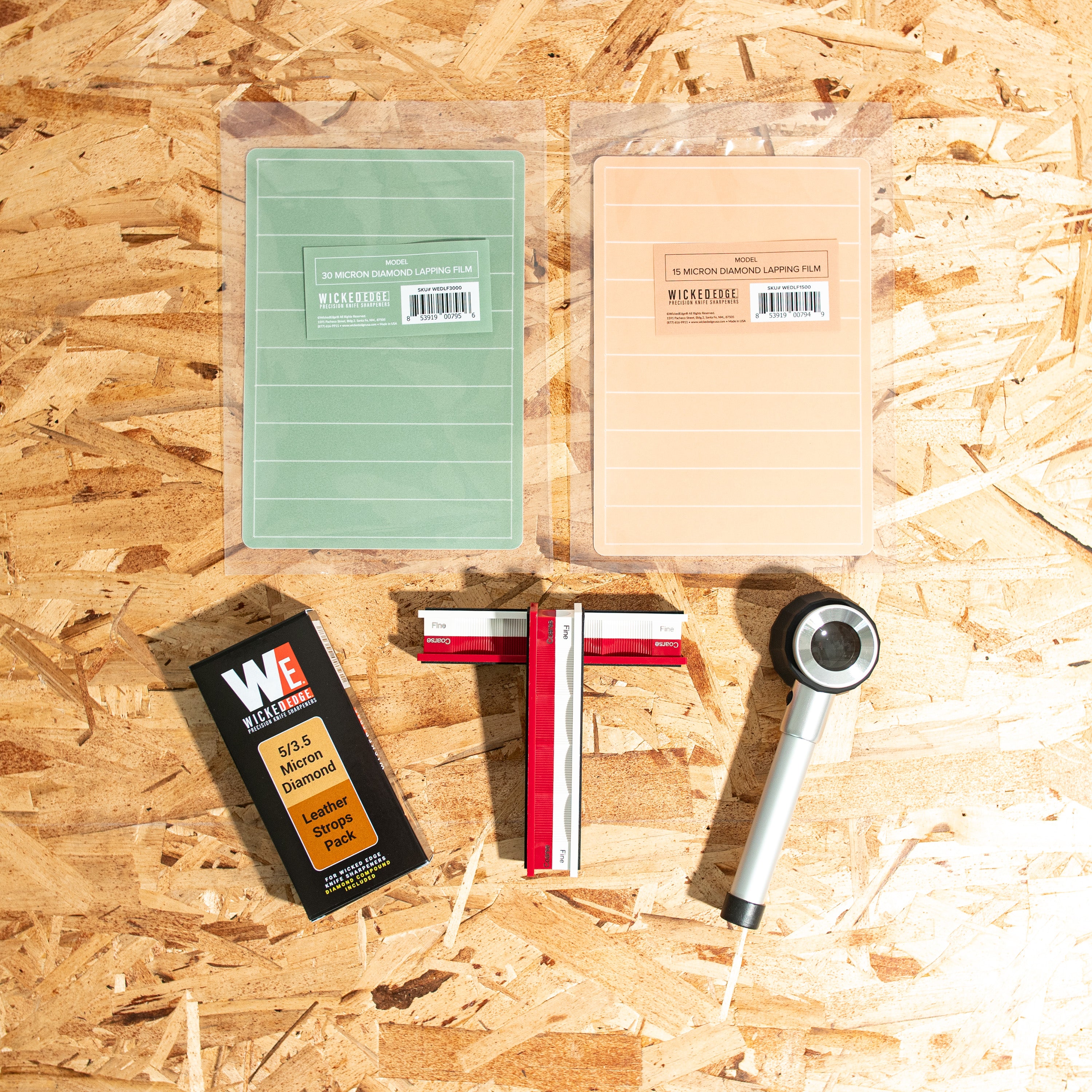 Edge Kit V (Field Dressing) leather strops and lapping films in close-up flat lay from above.