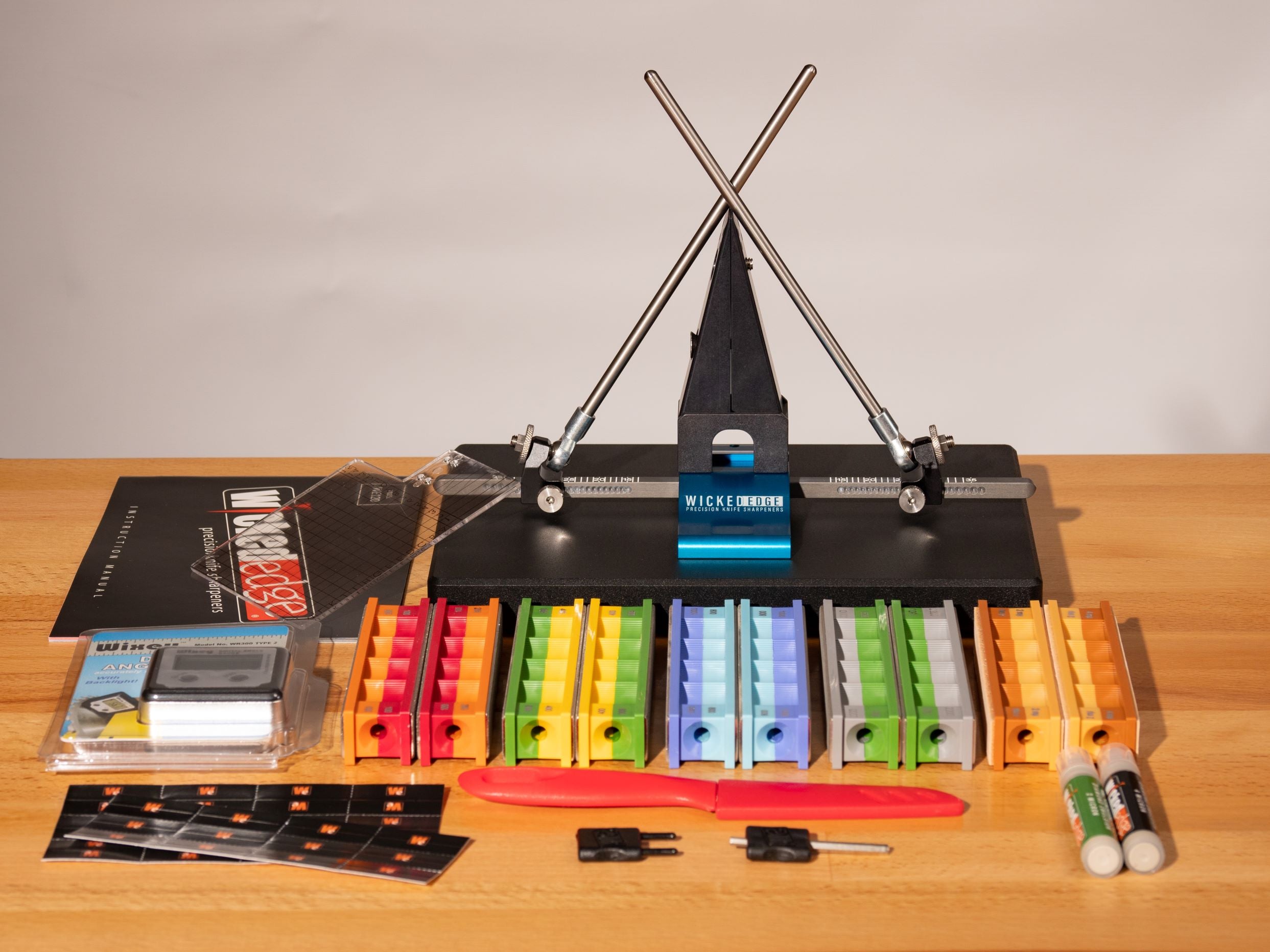 Pro-Pack II knife sharpening kit with colorful diamond stones and strops arranged on table in studio lighting from high angle view.