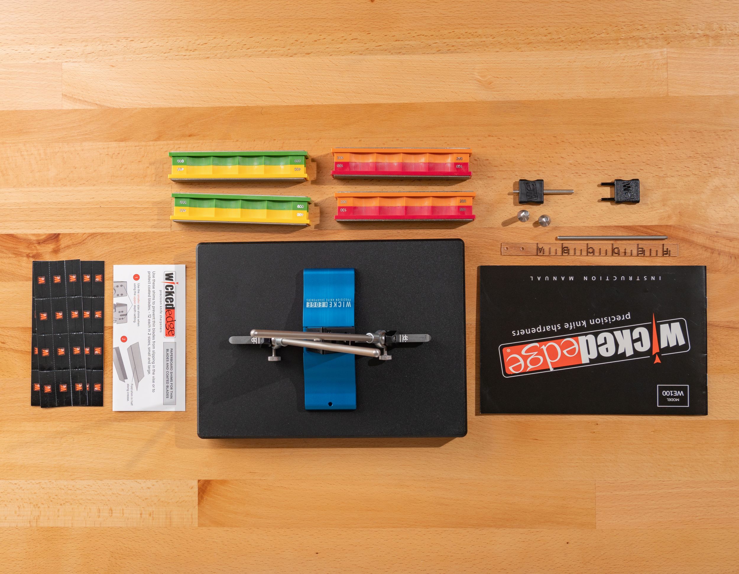 Wicked Edge WE100 precision knife sharpener in product unboxing scene at close-up zoom from top-down angle.