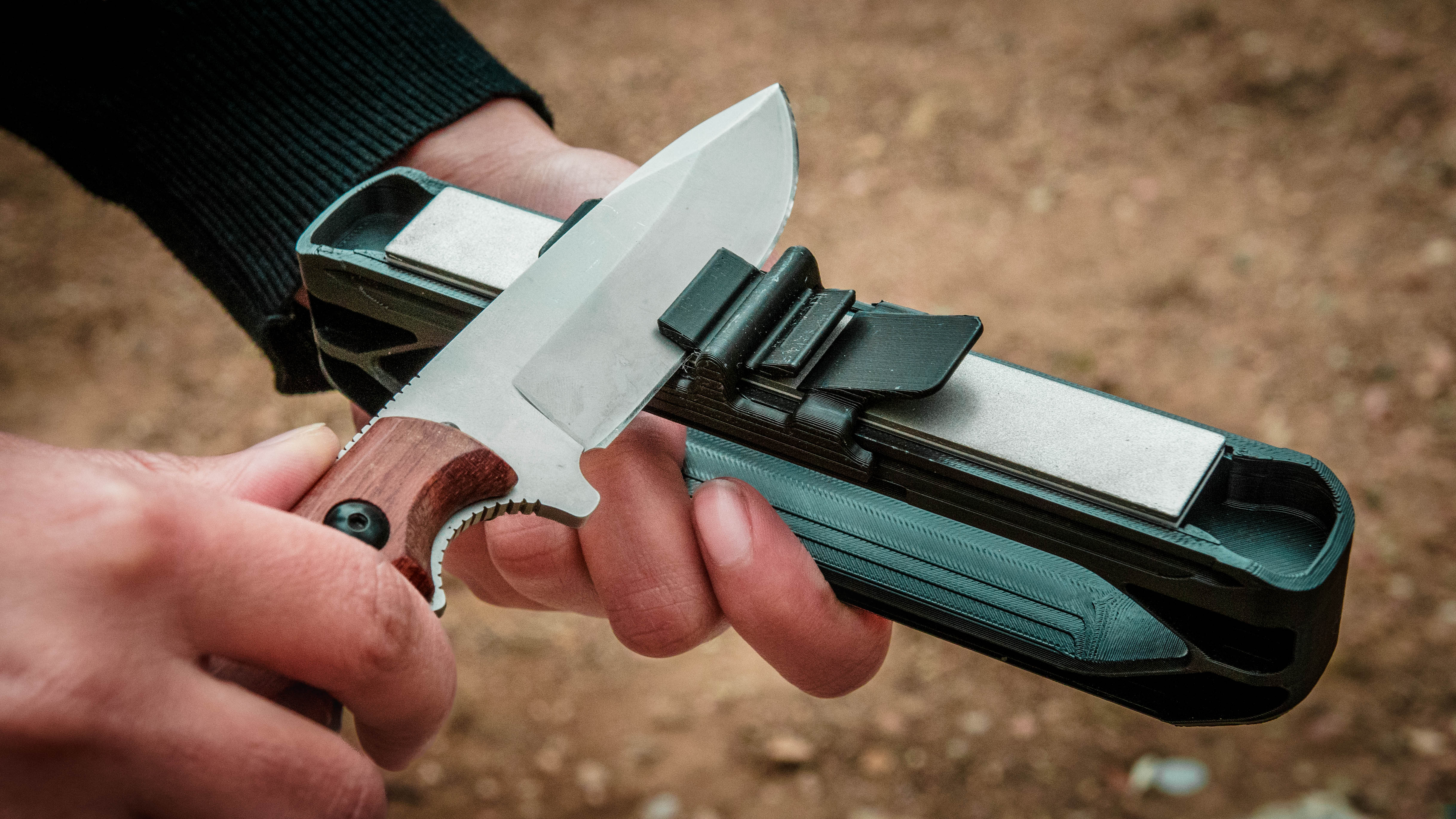A field knife being sharpened on the Venture knife sharpener